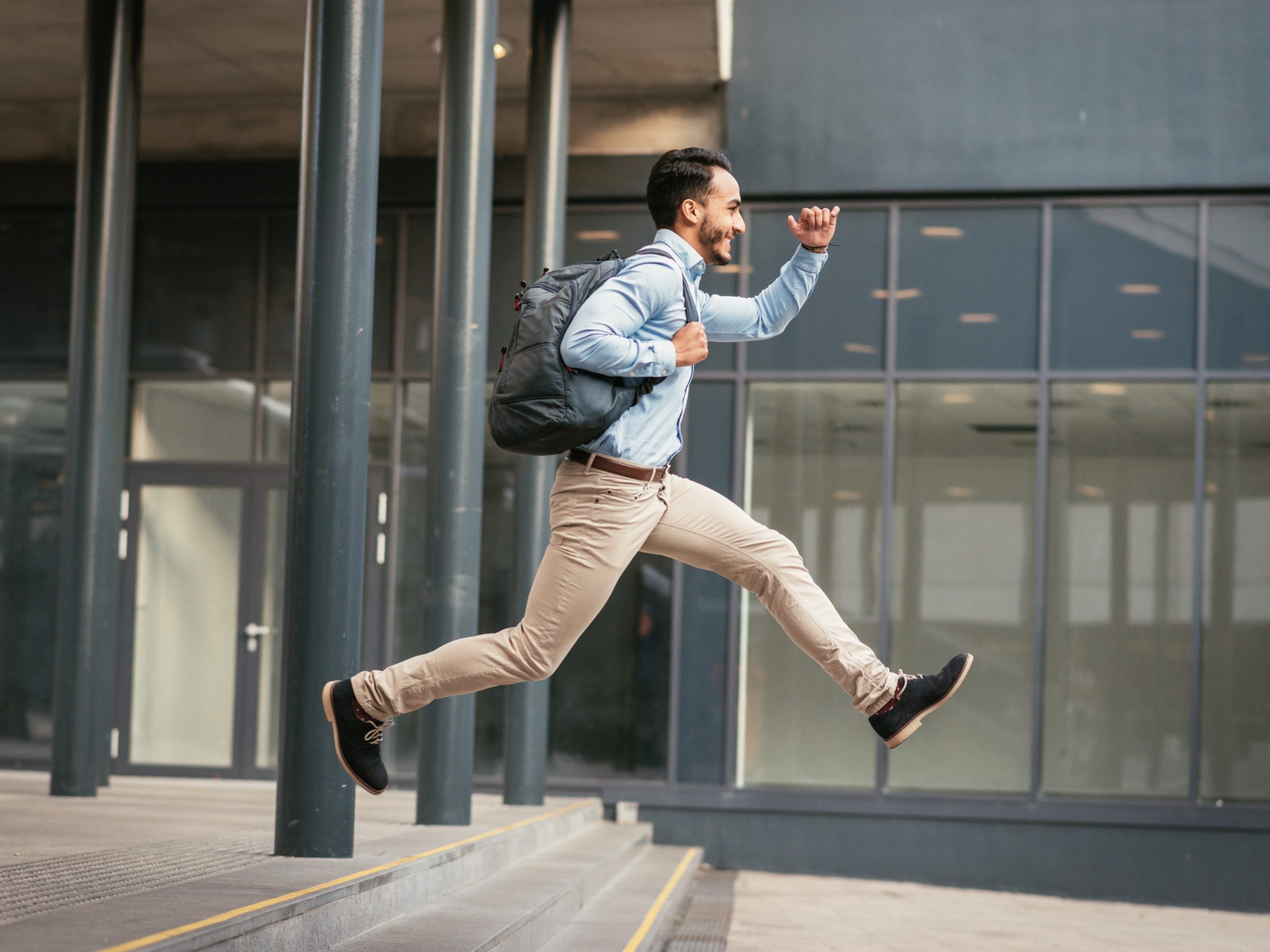 Successful 30 year old businessman dressed in smart casual clothing going for short business trip by train and local transportation.