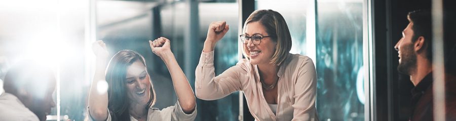 Shot of colleagues celebrating during a meeting in a modern office