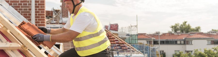 Urban roofers roofer laying roof tiles construction worker wearing hard hat