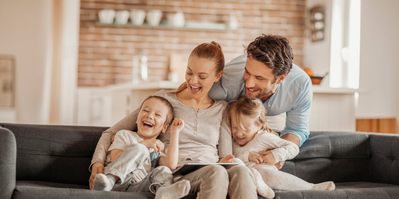 Close up of a happy young family having good time together.